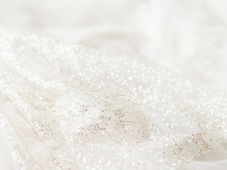 Bride's ivory colored dress with sparkling spangles. Bridal traditional clothing for wedding ceremony.