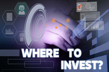 Text sign showing Where To Invest question. Business photo showcasing asking about actions or process of making more money Male human wear formal work suit presenting presentation using smart device