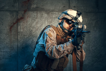 Fototapeta premium American private military contractor shooting a rifle. Studio shot