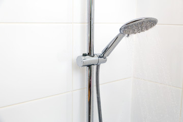  Chrome shower on white tile.Horizontally, Vertically.