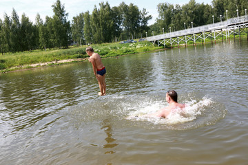 Child jumping into lake