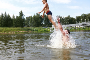 Kid jumping into lake