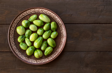 green tomatoes closeup. tomatoes on a plate top view. background with tomatoes. copy space. flat lay.