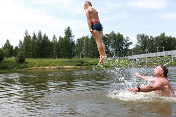 Son jumping into lake