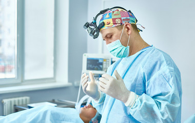 Several doctors surrounding patient on operation table during t