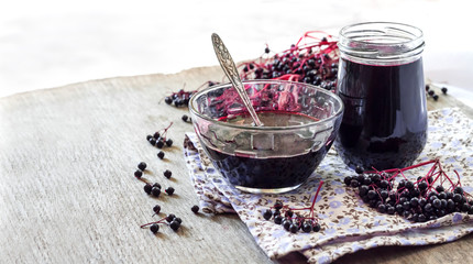 Homemade black elderberry syrup in glass jar