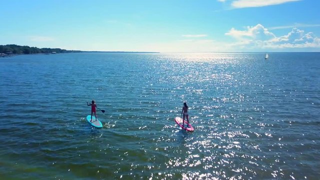 A beautiful aerial drone shot of a paddle board out in the vast ocean