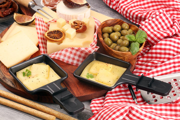 Delicious traditional Swiss melted raclette cheese on diced boiled or baked potato and baguette...