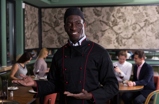 Smiling African American Chef Inviting To Restaurant