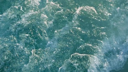 Blue sea water with boat trace. Slow motion.