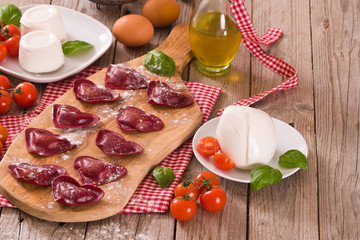 Red heart ravioli with tomato, mozzarella and basil. 