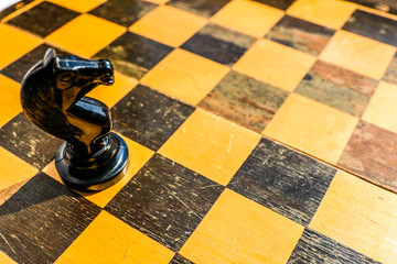 Chess chess knight on chessboard. No man is an island concept. © Anton