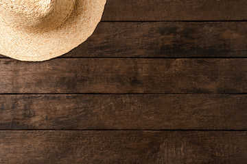 Fototapeta na wymiar Straw hat on wooden table. Summer background