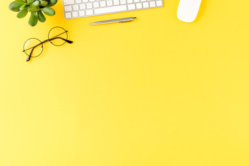 Overhead shot of business accessories on yellow background with copyspace. Office desktop