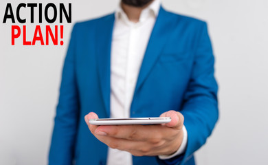 Word writing text Action Plan. Business photo showcasing proposed strategy or course of actions for certain time Business concept with man holding mobile phone with touch screen