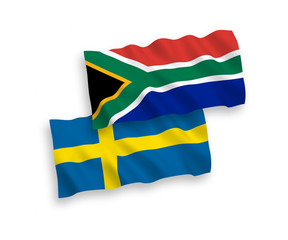 National vector fabric wave flags of Sweden and Republic of South Africa isolated on white background. 1 to 2 proportion.