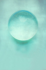 glass ball on textured background - Neo Mint - Trend Color 2020
