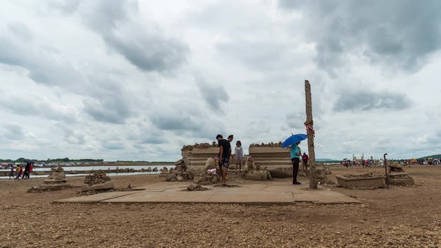 time lapse of people visit the ruins of Nong-Bua temple under the water of Pasak Jolasid Dam after the water reduced in Lopburi, Thailand