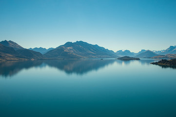 Fototapeta na wymiar Amazed nature scenic landscape of invisibly mountain, clear blue sky reflection in turquoise lake, popular view point on the way to Glenorchy, South New Zealand.