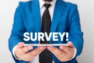 Obraz premium Handwriting text writing Survey. Conceptual photo research method used for collecting data from a predefined group Businessman in blue suite with a tie holds lap top in hands