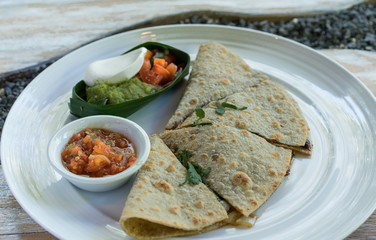 Vegan tortilla wrap, with vegetabes on a wooden background