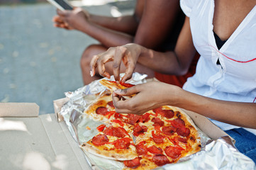 Obraz na płótnie Canvas Hands of african american woman with pizza.