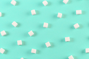 Geometry Pattern made of white sugar cubes on light blue background. Abstract, minimal style.