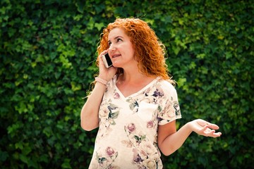 redhead woman talking with her cellphone