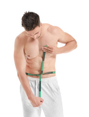 Handsome muscular man with measuring tape on white background. Weight loss concept