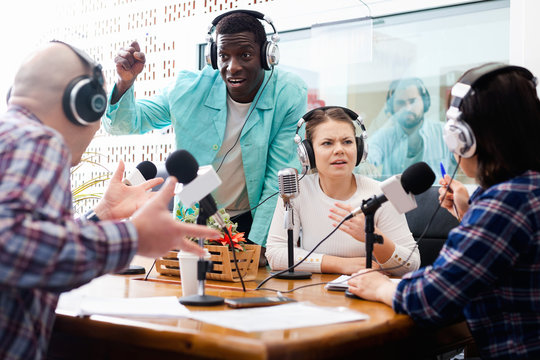 Scandal interview. Two outraged guests answering provocative questions of radio hosts during live radio show