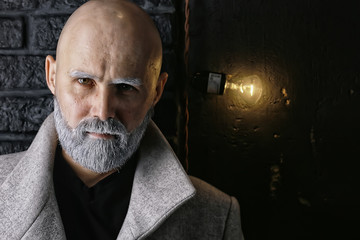 Santa Claus hipster / portrait of a fashionable modern Santa, young man with a gray beard, Christmas winter portrait