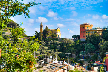 Fototapeta na wymiar Portofino, Italy - AUGUST 15, 2019: view of the Church of San Giorgio, the vicinity of Portofino / Italian Riviera