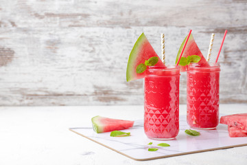 Glasses of of fresh watermelon juice on table