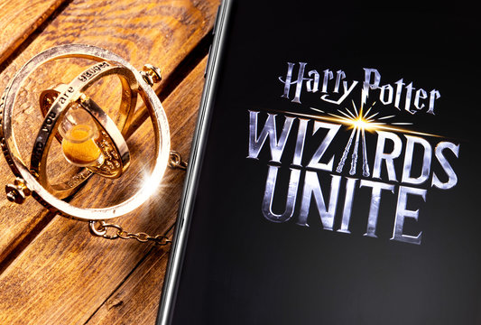 Time-Turner and smartphone with Harry Potter: Wizards Unite - is a free game for augmented reality, based on locations, inspired by the Wizarding World. Moscow, Russia - May 16, 2019