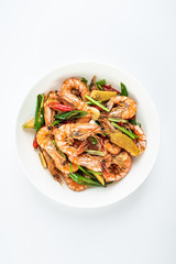 Chinese dish of spicy spicy black shrimp on white background