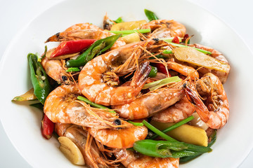 Chinese dish of spicy spicy black shrimp on white background