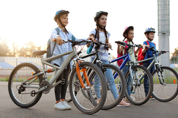 Obraz premium Cute children riding bicycles outdoors