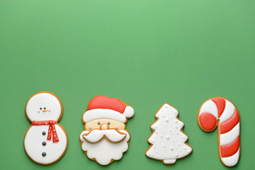 Tasty Christmas cookies on color background