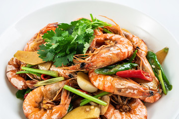 Chinese dish of spicy spicy black shrimp on white background