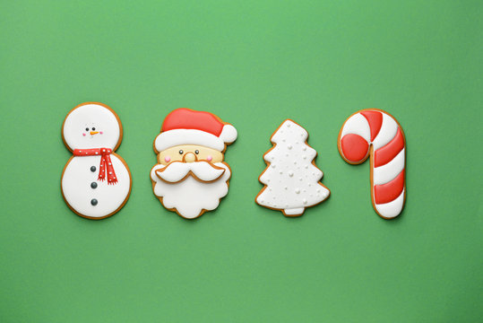 Tasty Christmas cookies on color background
