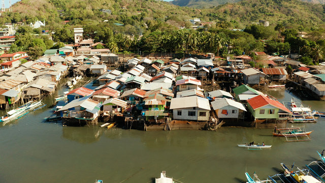 Old Wooden House Standing On The Sea In The Fishing Village. Busuanga, Coron, Philippines. Houses Community Standing In Water In Fishing Village. Coron City With Slums And Poor District.