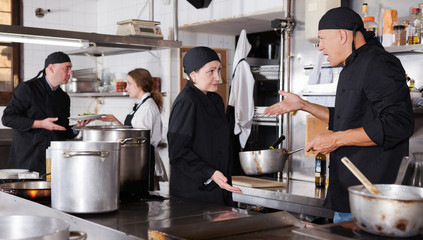 Chef male dissatisfied with the work of girl help
