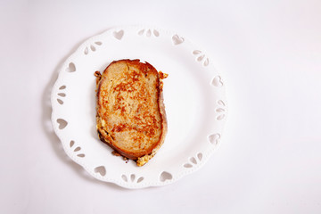 egg toast on white porcelain plate with heart (fried in hot oil)