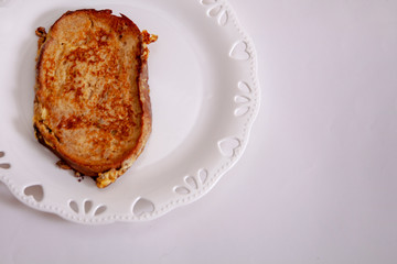 egg toast on white porcelain plate with heart (fried in hot oil)
