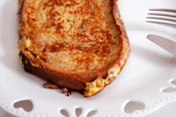 egg toast on white porcelain plate with heart (fried in hot oil)