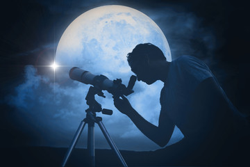 Astronomer with a telescope watching at the stars and Moon. My astronomy work.