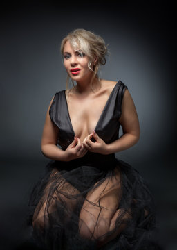 Beautiful sexy model, erotick studio shoot. At grey background.