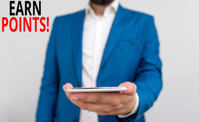 Word writing text Earn Points. Business photo showcasing collecting scores in order qualify to win big prize Business concept with man holding mobile phone with touch screen