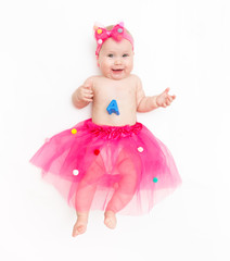 Portrait of a sweet infant wearing a pink tutu and headband bow, isolated on white in studio