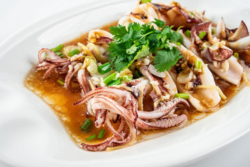 Chinese Cantonese cuisine home cooking, a dish of garlic steamed tubule squid on a white background